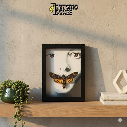 deaths head hawkmoth acherontia atropos in frame with silence of the lambs motive standing on a shelf